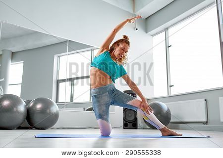 Attractive Sportswoman Doing Exercises On The Floor In The Modern Palates Studio Beautiful Sportive 