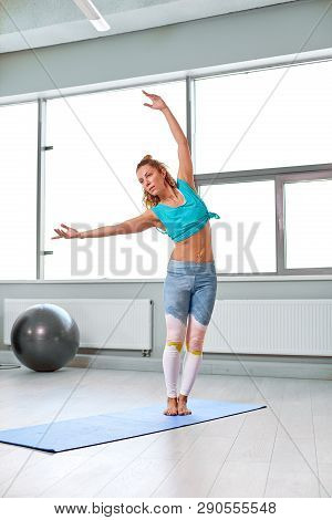 Attractive Sportswoman Doing Exercises On The Floor In The Modern Palates Studio Beautiful Sportive 