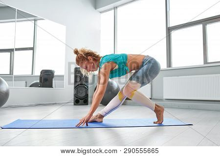 Attractive Sportswoman Doing Exercises On The Floor In The Modern Palates Studio Beautiful Sportive 