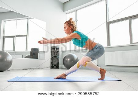 Attractive Sportswoman Doing Exercises On The Floor In The Modern Palates Studio Beautiful Sportive 