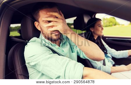 leisure, road trip, travel and people concept - woman learning to drive car and scared man covering face with his palm