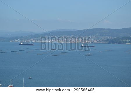 Raxo Bay With The Mussel And Oil Boats Breeding Through It. Nature, Architecture, History. August 19