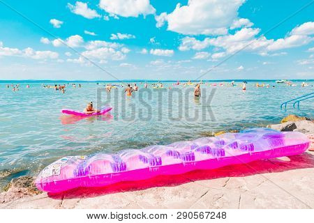 Balaton, Hungary - July 14, 2018: People Swimming In Blue Azure Lake. Summer Travel