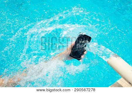 Waterproof Phone Which Is Directed To A Large Jet Of Water. Male Hand Is Holding A Phone Under The W