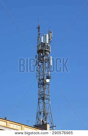 Radio Tower With Antennas On A Blue Sky Background. Metal Construction. Wireless Network. Transmit T