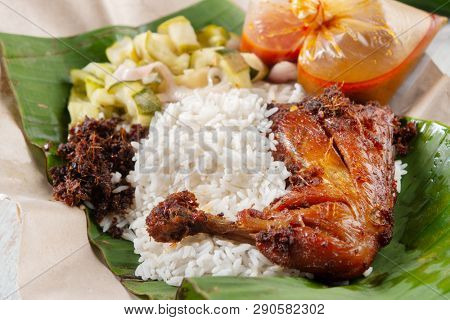 Nasi lemak kukus with chicken, popular traditional Malay local food.