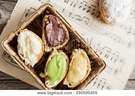 Homemade Profiteroles On The Music Sheet With Notes. Profiteroles (choux à La Crème) - French Choux