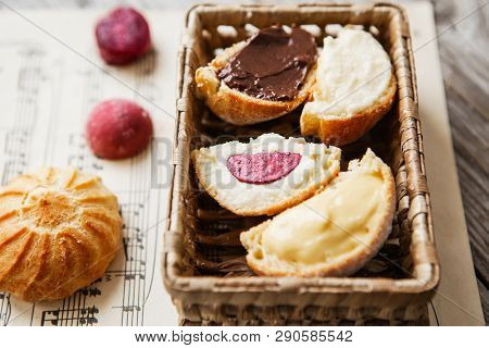 Homemade Profiteroles On The Music Sheet With Notes. Profiteroles (choux à La Crème) - French Choux