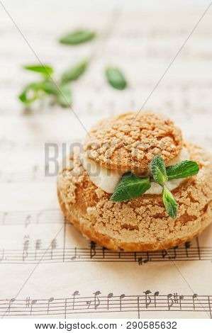 Homemade Profiteroles On The Music Sheet With Notes. Profiteroles (choux à La Crème) - French Choux