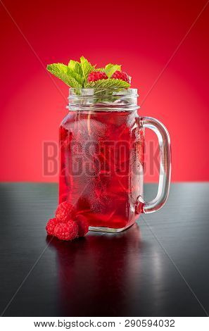 Homemade Berry Ice Tea On Red Background