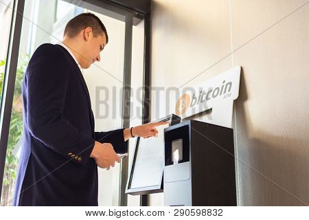 Bitcoin Atm Machine Being Used By Businessman For Buying Cryptocurrency And Other Altcoins
