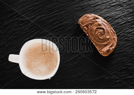 Coffee Cappuccino Or Latte Next To Bread With Chocolate On A Black Background Like Stone Mica