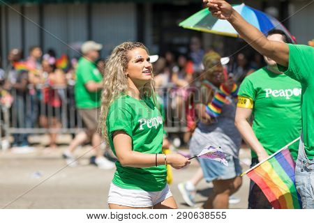 Chicago, Illinois, Usa - June 24, 2018: The Lgbtq Pride Parade, Men And Women Waving The Rainbow Fla