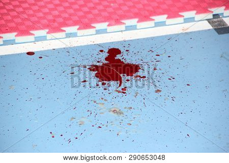 red blood on the floor from which the spray flew off