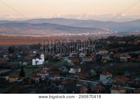 Scenic View Of Slavyani Village Church With Lovech City In The Background. Balkan Mountain Range In 
