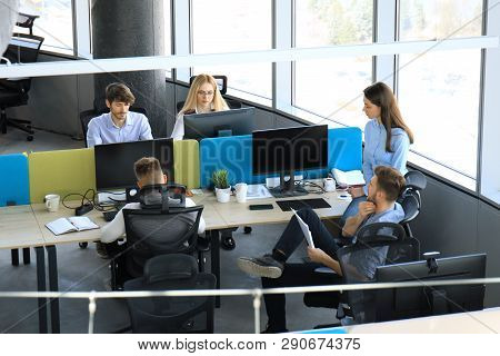 Top View Of Young Modern Colleagues In Smart Casual Wear Working Together While Spending Time In The
