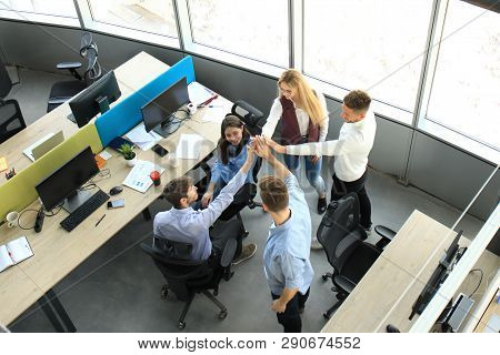 Top View Of Young Modern Colleagues In Smart Casual Wear Working Together While Spending Time In The