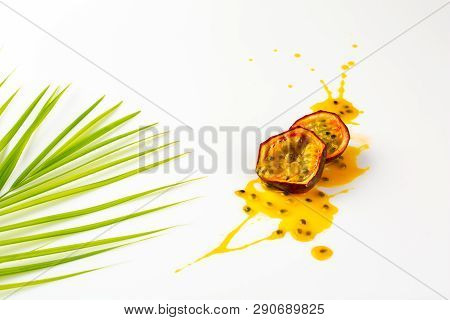 Passion Fruit And Bamboo Leaf Splasing. Cut Passion Fruit. Smear Or Blot Of Passion Fruit Juice On W