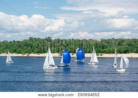 Regatta Competition On Lake River Sailing Yachts Boats With White Sails And Gennakers, Reflected Sky