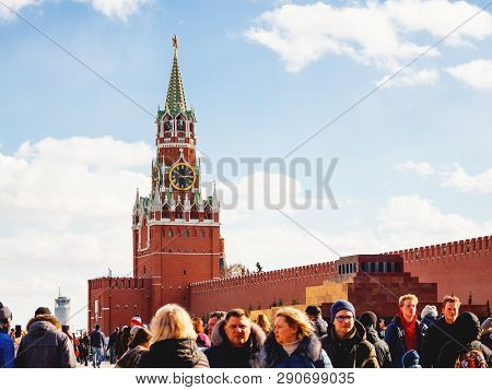 Moscow, Russia - March 09, 2019. Local People And Tourists Walking Near Famous Spasskaya Tower With 