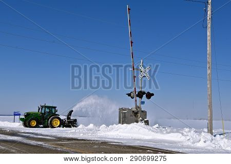 Moorhead, Minnesota, March 11, 2019:  The 6145r John Deere Tractor Blowing Snow Is A Product Of John