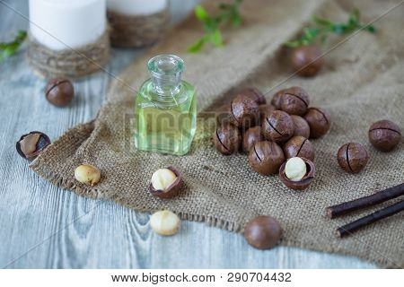 Macadam Nuts, Walnut Oil, On Wooden Background. Relax, Health Care, Body Care