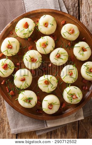Polish Authentic Kluski Potato Dumplings With Bacon And Green Onions Close-up On A Plate. Vertical T