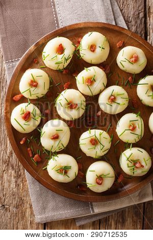 Homemade Round Potato Dumplings With Bacon And Green Onions Close-up On A Plate. Vertical Top View