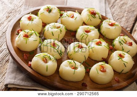 Freshly Made Potato Dumplings With Bacon And Green Onions Close-up On A Plate. Horizontal