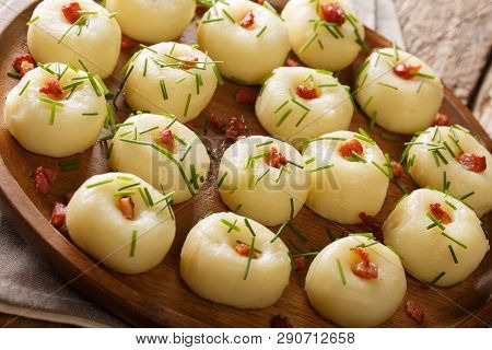 Homemade Round Potato Dumplings With Bacon And Green Onions Close-up On A Plate. Horizontal