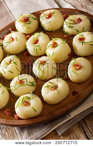 Polish Potato Dumplings With Bacon And Green Onions Close-up On The Table. Vertical