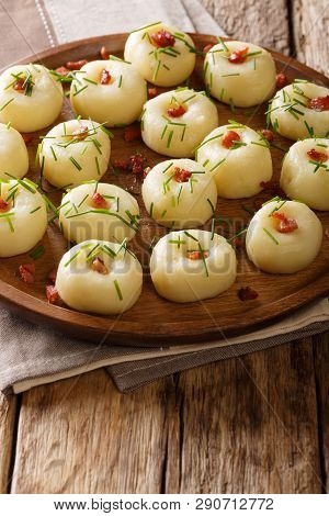 Silesian Traditional Potato Dumplings With Bacon And Green Onions Close-up On A Plate. Vertical