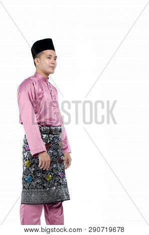 Portrait Of Young And Handsome Asian Man With Traditional Clothing During Hari Raya Over White Backg