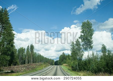 Fields, Trees And Road With Blue Sky And Clouds
