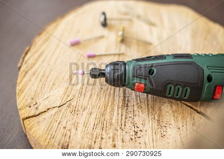 Drill Rotary Tool With Accessories, Dremel Tool Heads. Multi Tool On Wooden Table In Jeweler Worksho