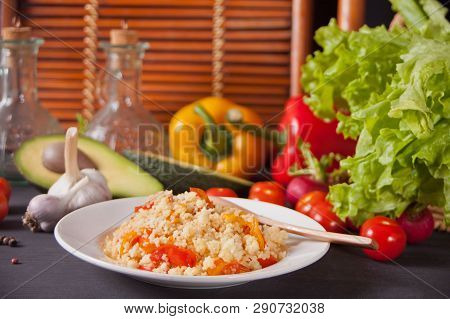 Homemade Vegetarian Couscous With Tomatoes, Carrots, Pepper On A Dark Kitchen Table With Vegetables 