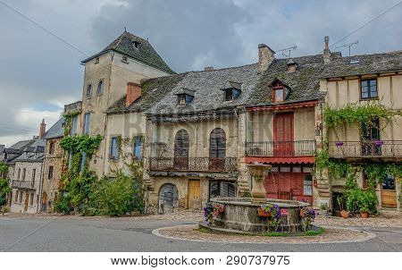 Najac, Midi Pyrenees, France - September 16, 2017: Idyllic Old Square With Fountain, In Front Of A F