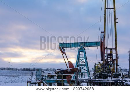 Oil And Gas Industry. Silhouette Oil Pumps On A Sunset Sky Background.oil Industry Equipment. Close 