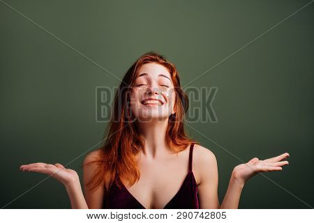 Happy Young Woman Portrait. At Last. Smiling Redhead Female With Open Palms. Eyes Closed. Copy Space