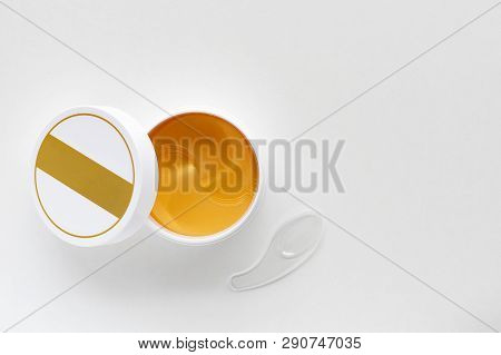 Open Jar With Hydrogel Patches For Eyes. Gold Energy Hydrogel Eye Patch. Top View With Copy Space.