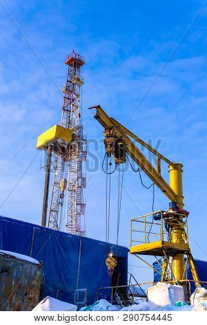 Oil And Gas Drilling Rig Onshore Dessert With Dramatic Cloudscape. Oil Drilling Rig Operation On The