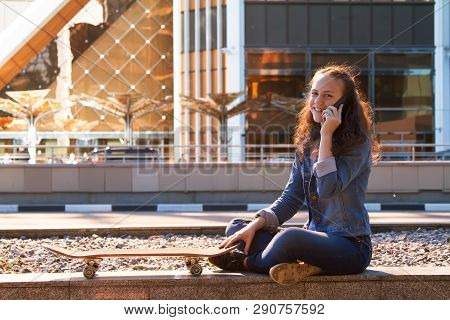 Happy Teen Girl Talk By A Mobile Phone Talk In A Big City
