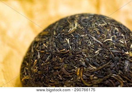 Chinese Pressed Puer Tea On Wrapping Paper, Close-up, Macro