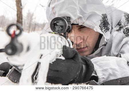 Closeup Portrait Man Soldier In The Winter On A Hunt With A Sniper Rifle In White Winter Camouflage