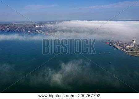 Aerial View Of Panoramic Seaport Warehouse And Container Ship, Crane Vessel Working For Delivery Of