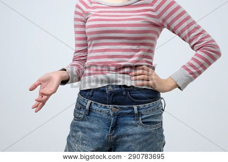 Woman Wearing Two Jeans Pants. Strange And Odd Fashion. She Is Very Sloppy