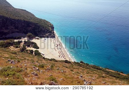 Summer Albania Beach View. Ionian And Adriatic Sea. Seashore With Wave Sand Rock Stone Sky And Sun. 