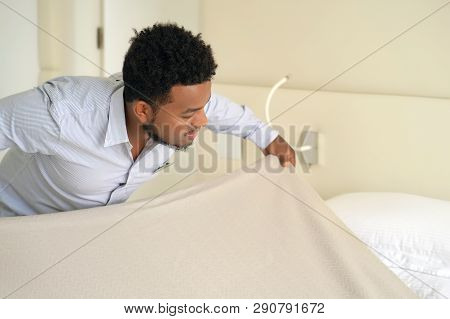 Maid Making Bed In Hotel Room. Staff Maid Making Bed. African Housekeeper Man Making Bed.