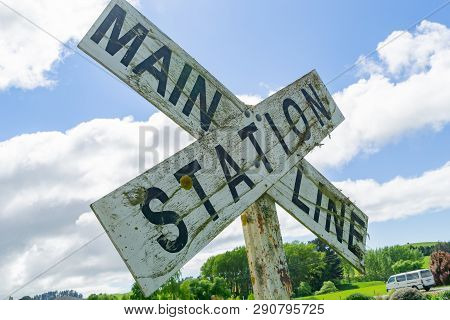 Old Railway Crossing Sign Reading Mainline Station.
