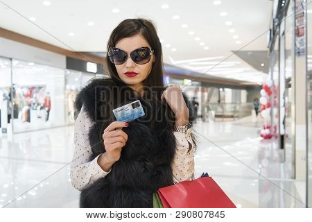 Attractive Brunette With Many Shopping Bags After Spending Credit Money At Shopping Centre Backgroun